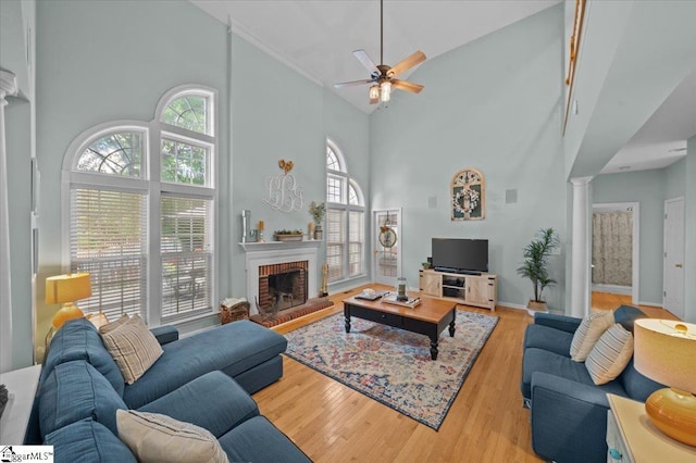 2 Willow Oak Ct, Simpsonville, SC 29681 - living room with high vaulted ceiling, ornate columns, ceiling fan, wood finished floors, and a fireplace