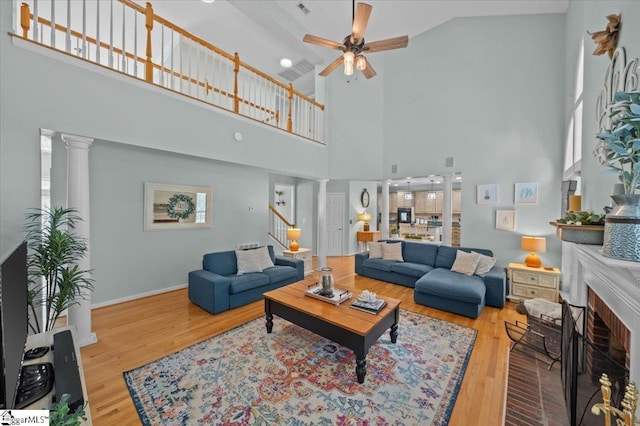 2 Willow Oak Ct, Simpsonville, SC 29681 - living room featuring ornate columns, a towering ceiling, wood finished floors, and a ceiling fan