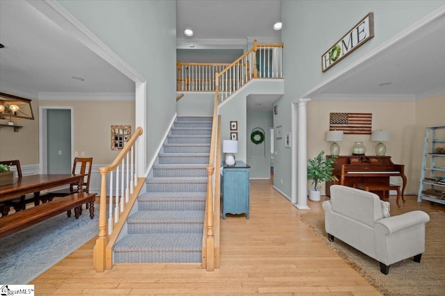 2 Willow Oak Ct, Simpsonville, SC 29681 - staircase with wood finished floors, a high ceiling, and ornamental molding