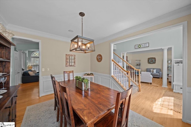2 Willow Oak Ct, Simpsonville, SC 29681 - dining space featuring crown molding, a chandelier, light wood-style floors, wainscoting, and stairway