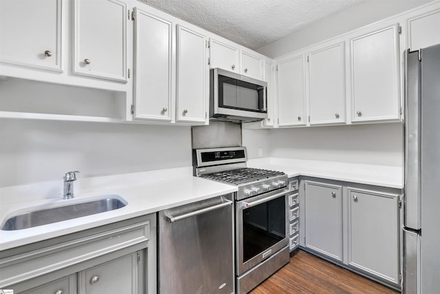 601 Cleveland St Unit 3A, Greenville, SC 29601 - kitchen featuring appliances with stainless steel finishes, light countertops, a textured ceiling, open shelves, and gray cabinetry