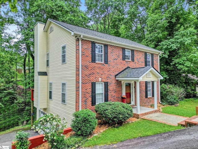 105 Devonshire Ln, Greenville, SC 29617 - view of front of property featuring a chimney, brick siding, a shingled roof, and view of scattered trees