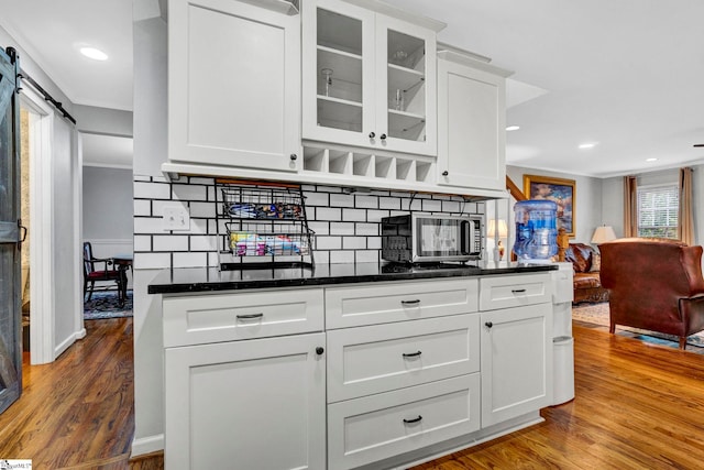 105 Devonshire Ln, Greenville, SC 29617 - kitchen with wood finished floors, backsplash, white cabinetry, glass insert cabinets, and recessed lighting