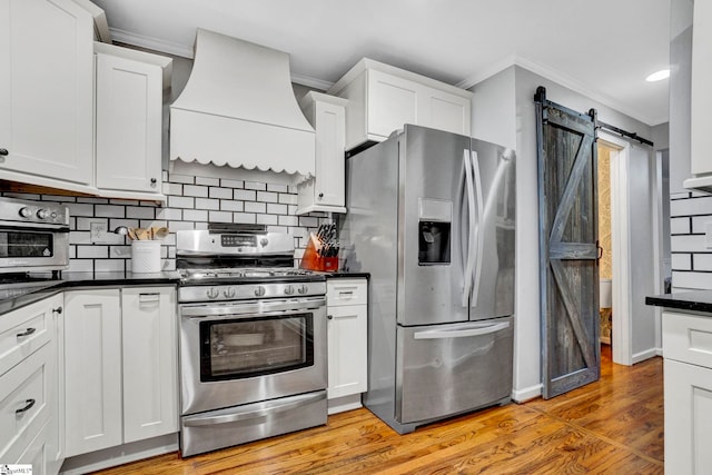 105 Devonshire Ln, Greenville, SC 29617 - kitchen featuring appliances with stainless steel finishes, premium range hood, dark countertops, crown molding, and white cabinetry