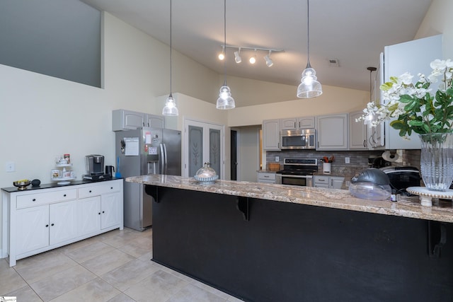 6 Gratiot Ln, Greer, SC 29651 - kitchen featuring appliances with stainless steel finishes, a peninsula, decorative backsplash, light stone countertops, and high vaulted ceiling