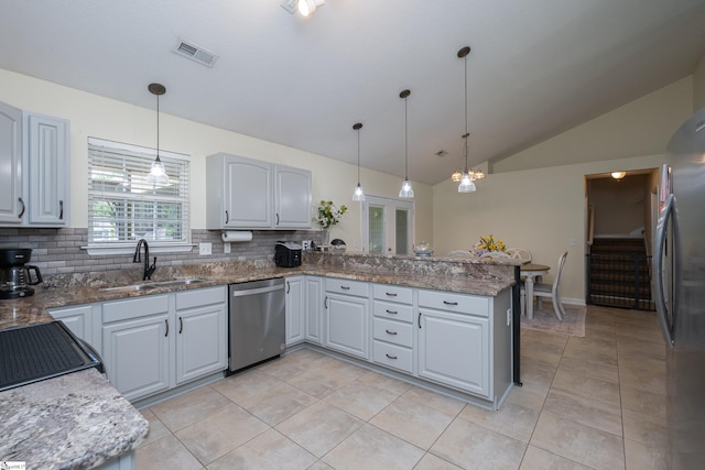 6 Gratiot Ln, Greer, SC 29651 - kitchen with appliances with stainless steel finishes, lofted ceiling, backsplash, a peninsula, and decorative light fixtures