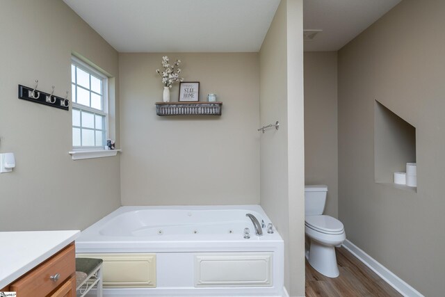 6 Gratiot Ln, Greer, SC 29651 - bathroom with a jetted tub, wood finished floors, and vanity