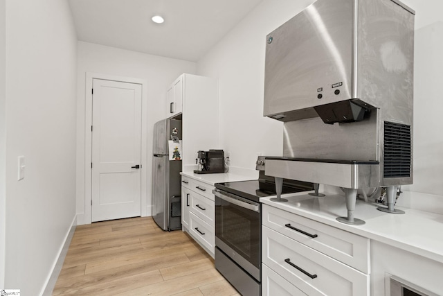 421 Lynn Rd, Taylors, SC 29687 - kitchen featuring stainless steel appliances, white cabinetry, light countertops, light wood-style floors, and recessed lighting