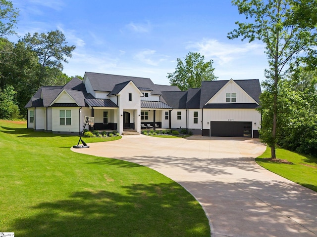 421 Lynn Rd, Taylors, SC 29687 - modern farmhouse style home featuring a porch, curved driveway, a front lawn, a standing seam roof, and a garage