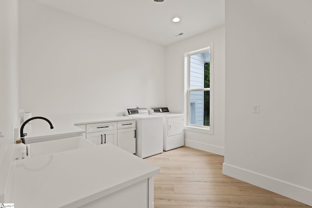 421 Lynn Rd, Taylors, SC 29687 - laundry area featuring washing machine and clothes dryer, cabinet space, light wood-type flooring, and recessed lighting