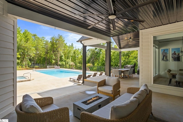 421 Lynn Rd, Taylors, SC 29687 - view of patio featuring a ceiling fan, an outdoor pool, outdoor dining area, an outdoor living space with a fire pit, and view of scattered trees