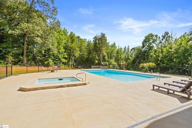 421 Lynn Rd, Taylors, SC 29687 - view of swimming pool with an in-ground hot tub, a patio area, and view of wooded area