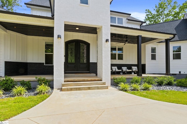 421 Lynn Rd, Taylors, SC 29687 - view of exterior entry featuring board and batten siding, a porch, and ceiling fan
