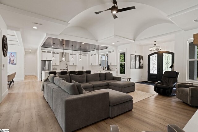 421 Lynn Rd, Taylors, SC 29687 - living room with ceiling fan, a chandelier, light wood-style flooring, and vaulted ceiling