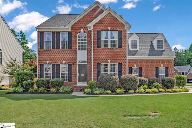 109 Amberleaf Way, Simpsonville, SC 29681 - colonial house featuring brick siding, a front yard, and roof with shingles
