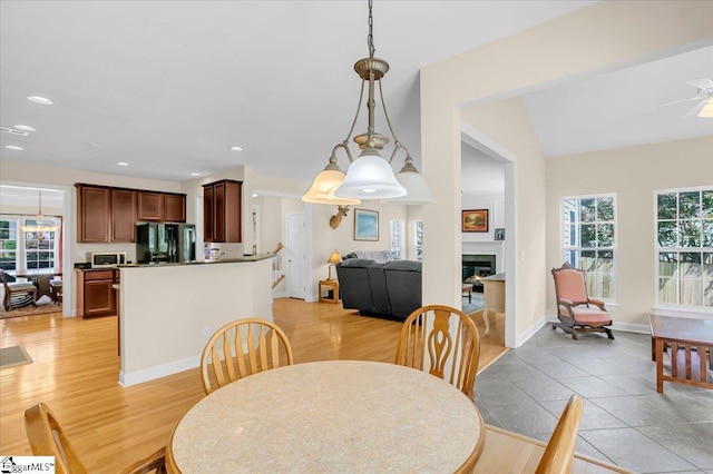 109 Amberleaf Way, Simpsonville, SC 29681 - dining room featuring a lit fireplace, light wood-style flooring, recessed lighting, and ceiling fan