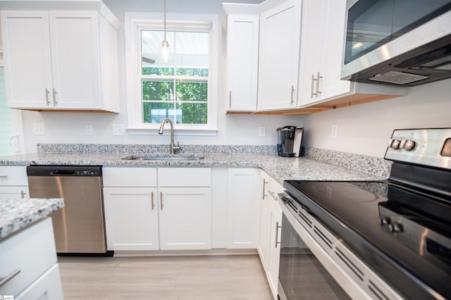 111 Caylee Way, Chesnee, SC 29323 - kitchen with appliances with stainless steel finishes, white cabinets, light wood-style flooring, and light stone countertops