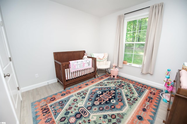 111 Caylee Way, Chesnee, SC 29323 - bedroom featuring multiple windows, wood finished floors, and a crib