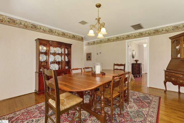 306 Verner Dr, Greenville, SC 29617 - dining room with wood finished floors, a chandelier, and ornamental molding