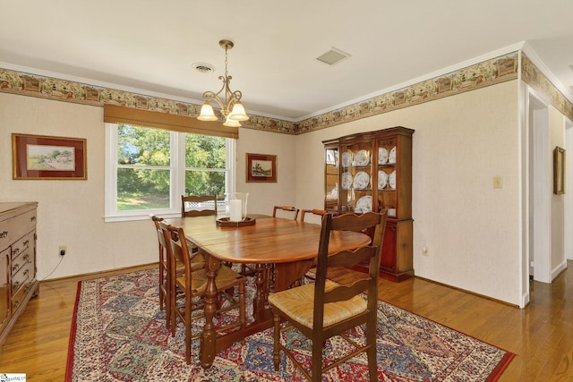 306 Verner Dr, Greenville, SC 29617 - dining room featuring a chandelier, light wood-style flooring, and ornamental molding