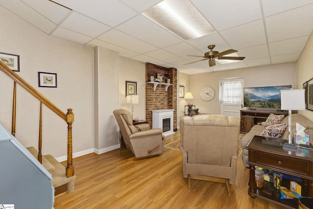 306 Verner Dr, Greenville, SC 29617 - living area with a paneled ceiling, light wood finished floors, stairway, ceiling fan, and a fireplace