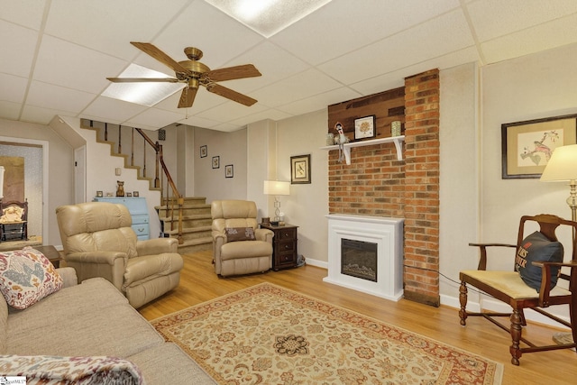 306 Verner Dr, Greenville, SC 29617 - living room with a drop ceiling, wood finished floors, stairway, a ceiling fan, and a fireplace