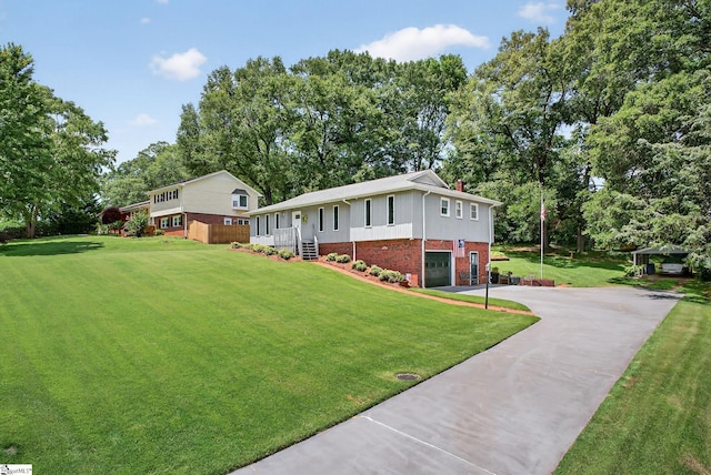 306 Verner Dr, Greenville, SC 29617 - view of front of house featuring brick siding, asphalt driveway, an attached garage, a front yard, and view of scattered trees