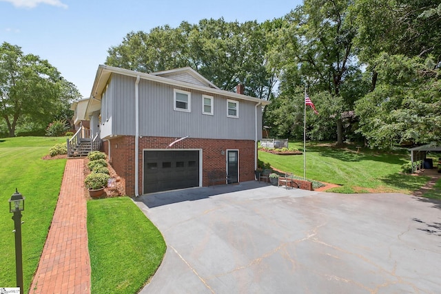 306 Verner Dr, Greenville, SC 29617 - view of side of home featuring asphalt driveway, a garage, brick siding, a yard, and a chimney
