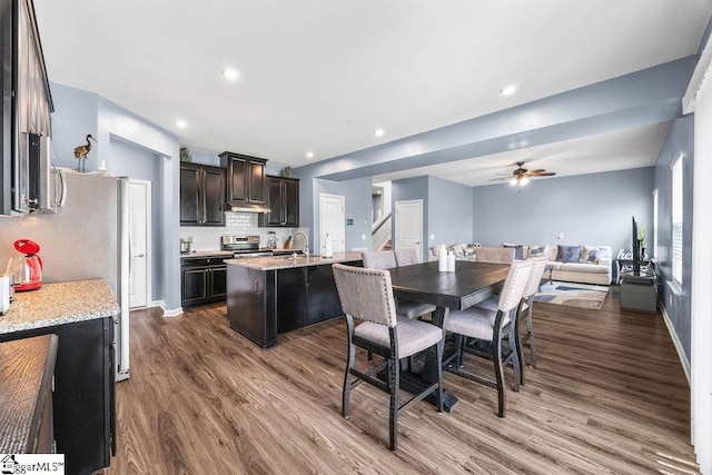 202 Huron Way, Greenville, SC 29607 - kitchen featuring dark wood finished floors, stainless steel range with electric stovetop, ceiling fan, open floor plan, and a kitchen island with sink