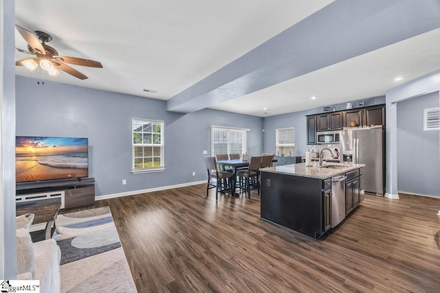 202 Huron Way, Greenville, SC 29607 - kitchen with stainless steel appliances, dark wood finished floors, ceiling fan, light stone countertops, and a kitchen island with sink
