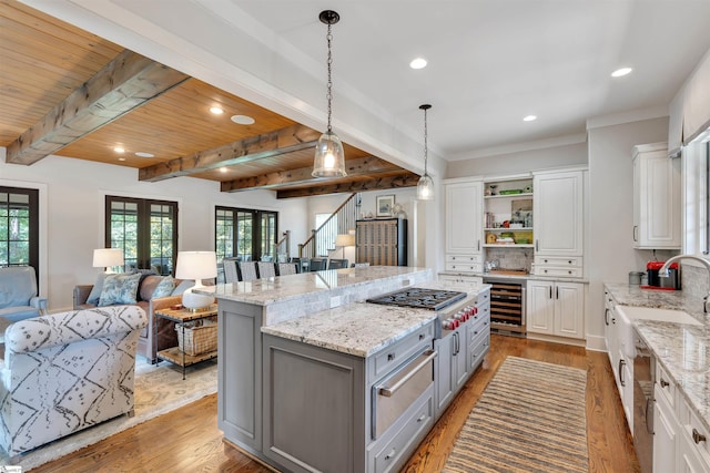 155 Village Point Dr, Sunset, SC 29685 - kitchen with gray cabinets, a warming drawer, stainless steel gas stovetop, open floor plan, and beverage cooler