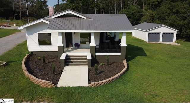 23 N Greenwood Avenue Extension, Ware Shoals, SC 29692 - view of front of property with a porch, a garage, a front yard, an outbuilding, and a metal roof