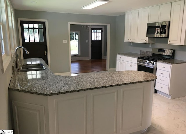 23 N Greenwood Avenue Extension, Ware Shoals, SC 29692 - kitchen with appliances with stainless steel finishes, white cabinetry, and dark stone countertops