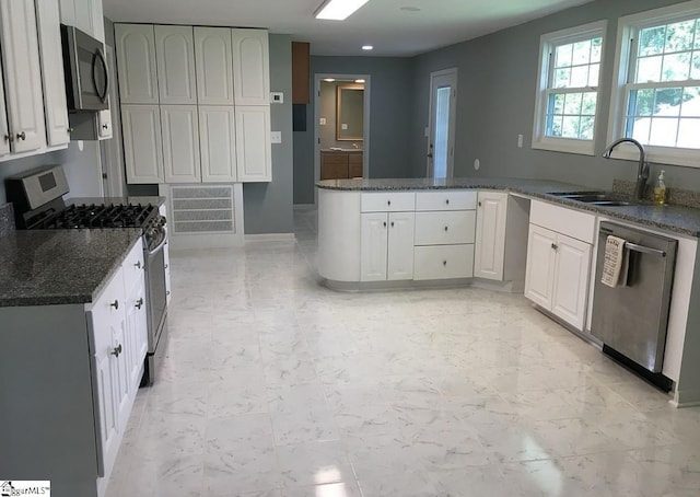 23 N Greenwood Avenue Extension, Ware Shoals, SC 29692 - kitchen featuring appliances with stainless steel finishes, dark stone countertops, a peninsula, white cabinets, and recessed lighting