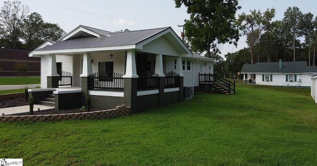 23 N Greenwood Avenue Extension, Ware Shoals, SC 29692 - view of front of property with a porch, a front yard, a metal roof, and stairway