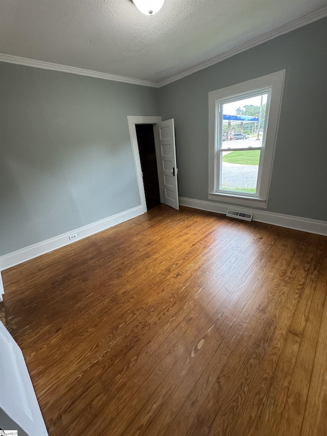 23 N Greenwood Avenue Extension, Ware Shoals, SC 29692 - empty room featuring wood finished floors, crown molding, and a textured ceiling