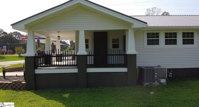 23 N Greenwood Avenue Extension, Ware Shoals, SC 29692 - rear view of property featuring a porch, a yard, and a metal roof