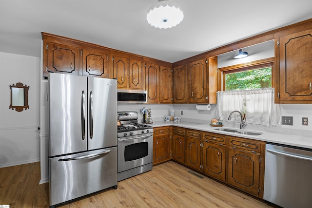 421 E Westbrooks Rd, Seneca, SC 29678 - kitchen featuring appliances with stainless steel finishes, light wood finished floors, light countertops, and brown cabinets