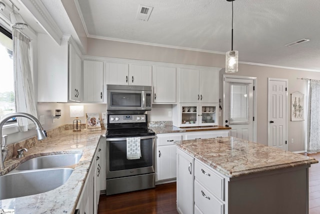 522 Reid School Rd, Taylors, SC 29687 - kitchen with stainless steel appliances, a center island, white cabinetry, crown molding, and dark wood-style flooring