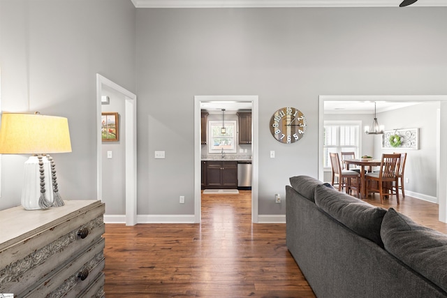 417 Addison Cir, Pelzer, SC 29669 - living room with dark wood-style flooring, crown molding, and a chandelier