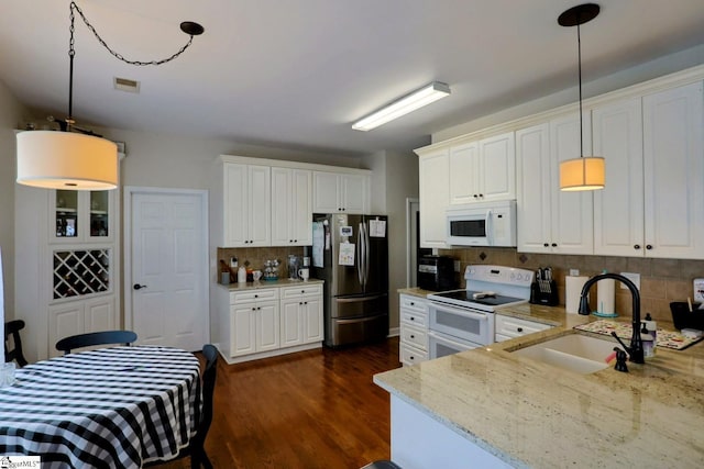 11 Hickory Hollow Ct, Greenville, SC 29607 - kitchen with white appliances, backsplash, light stone countertops, dark wood-type flooring, and white cabinets