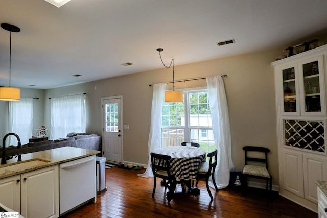 11 Hickory Hollow Ct, Greenville, SC 29607 - kitchen with dishwasher, white cabinetry, light stone countertops, hanging light fixtures, and dark wood-style flooring