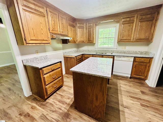10628 Augusta Rd, Belton, SC 29627 - kitchen with dishwasher, under cabinet range hood, light wood-style flooring, and brown cabinetry