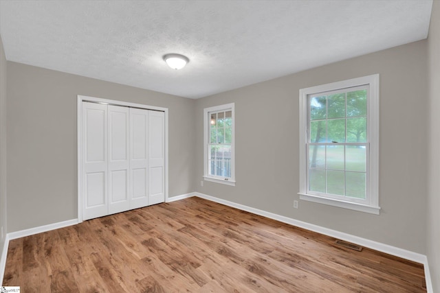 10628 Augusta Rd, Belton, SC 29627 - unfurnished bedroom featuring wood finished floors, a closet, and a textured ceiling