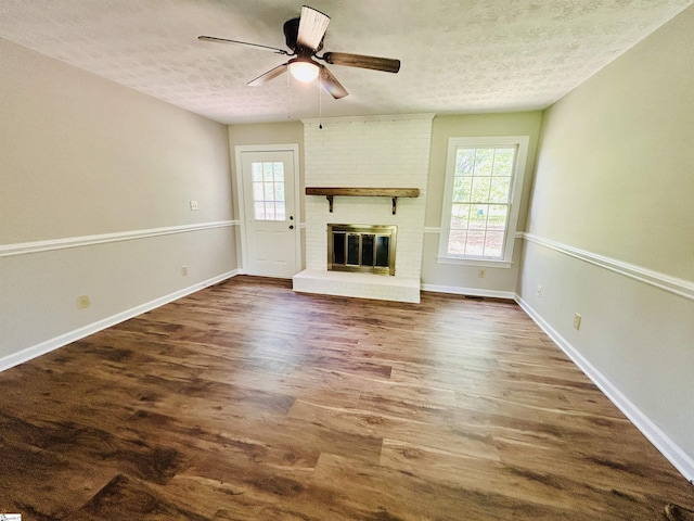 10628 Augusta Rd, Belton, SC 29627 - unfurnished living room with a textured ceiling, dark wood-style floors, ceiling fan, and a fireplace