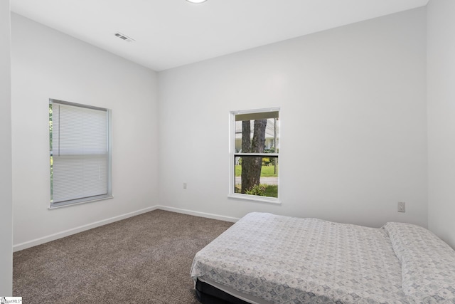904 W Hampton St, Laurens, SC 29360 - bedroom with baseboards and dark carpet