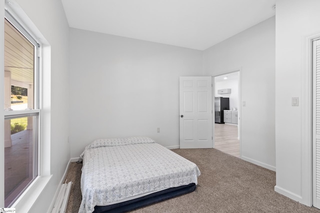 904 W Hampton St, Laurens, SC 29360 - carpeted bedroom with freestanding refrigerator and baseboards