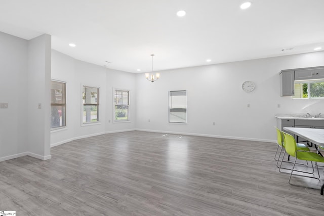 904 W Hampton St, Laurens, SC 29360 - unfurnished living room with recessed lighting, a chandelier, and wood finished floors
