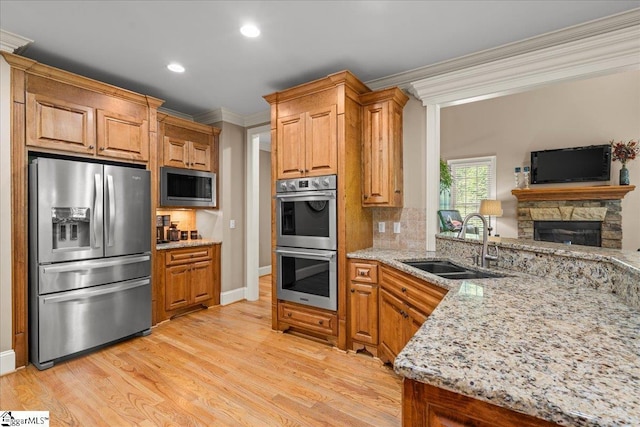 112 Griffith Hill Way, Greer, SC 29650 - kitchen featuring stainless steel appliances, ornamental molding, backsplash, light stone counters, and light wood-style floors