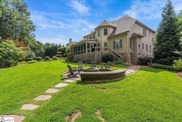 112 Griffith Hill Way, Greer, SC 29650 - back of house with a fire pit, a sunroom, a yard, and brick siding